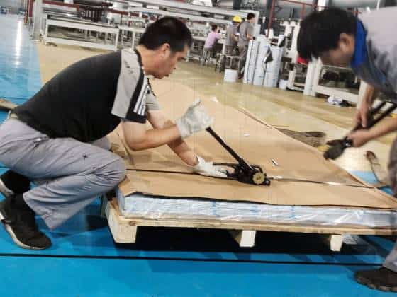 workers are packing aluminum sheets